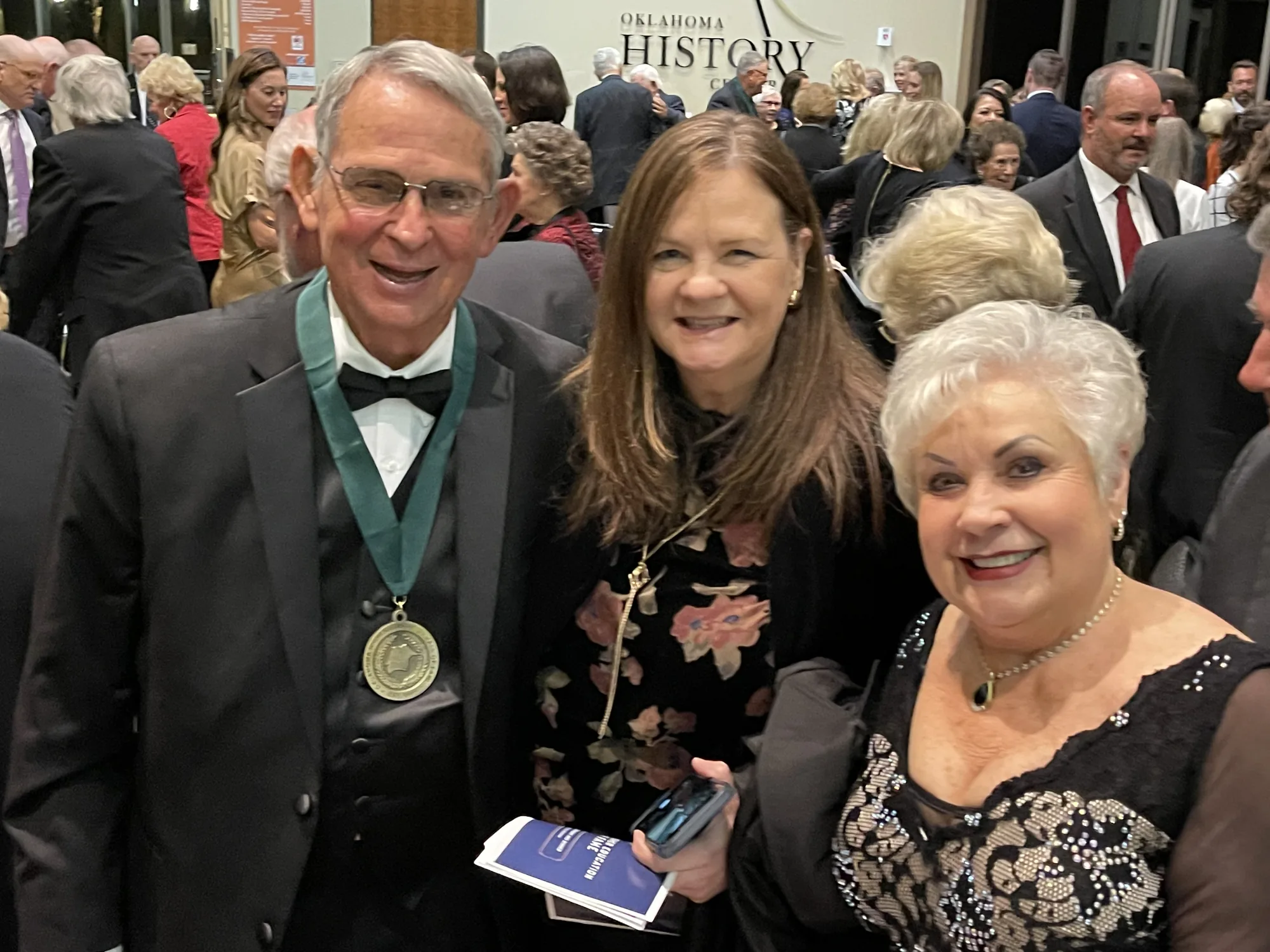 Carl Renfro wearing his Hall of Fame medal at the Oklahoma History Center, with Brenda Renfro
